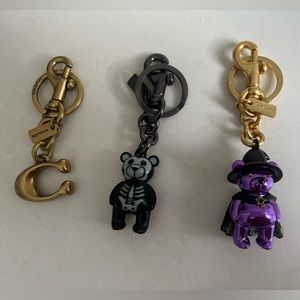 3 Coach keychains. Logo C and bears. Authentic, brand new condition.